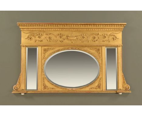 An early 19th century giltwood and gesso overmantle mirror, with centre oval bevelled glass, flanked by moulded columns and r