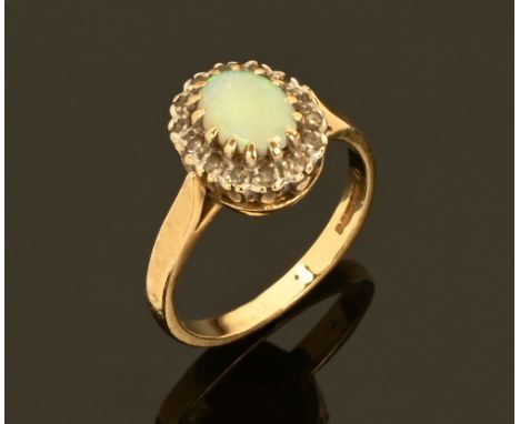 A 9 ct gold opal and diamond cluster ring.  Size O/P.