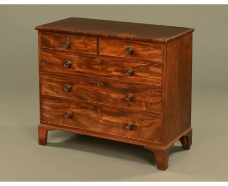 A George III mahogany chest of drawers, two short and three long with wooden knob handles and cockbeading to each drawer fron