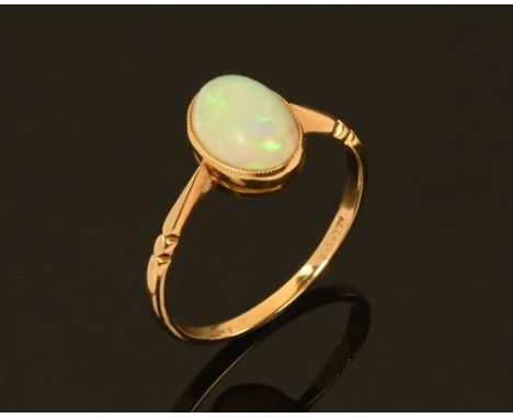 An 18 ct gold opal ring, stamped 18 ct. Size Q.