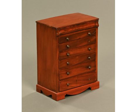 A 19th century mahogany miniature chest of drawers, with frieze drawer above six further drawers with brass knob handles and 