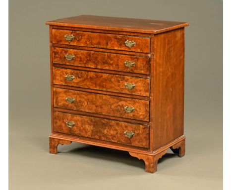 A 19th century mahogany and walnut chest of drawers, with moulded edge above five long graduated drawers with brass drop hand
