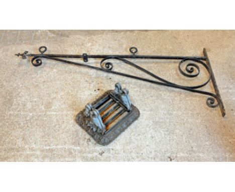 A 19th century wrought iron bracket, with indistinct makers mark. Length 140 cm, height 58 cm, together with a metal foot scr