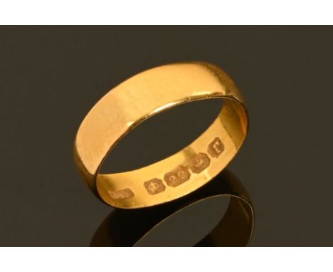 A 22 ct gold wedding band, 2.4 grams. CONDITION REPORT: The wedding band size is J/K but please note that the band is somewha