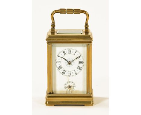 An early 20th century French brass carriage clock, with alarm, with porcelain dial.  Height excluding carrying handle 12 cm.