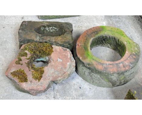 Two part sandstone mill wheels, and a small rectangular planter.  Largest diameter 43 cm.