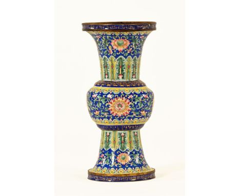 A 19th century Chinese enamel Gu form vase, all over decorated in foliate designs and with blue enamelled interior.  Height 1