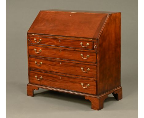 A George III mahogany bureau, with slope front to fitted interior and with four long graduated drawers with brass drop handle
