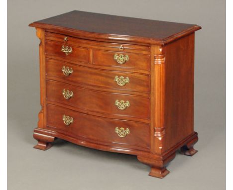 A George III style mahogany serpentine fronted reproduction chest of two short and three long drawers with brass drop handles