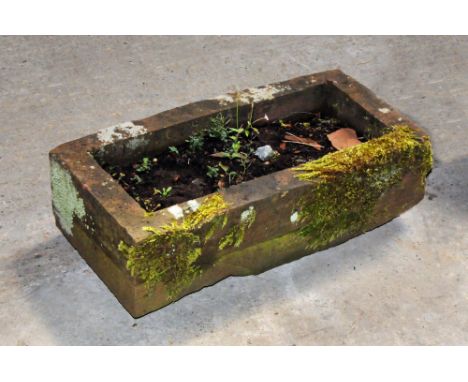 A rectangular sandstone trough.  Height 20 cm, width 64 cm, depth 32 cm.