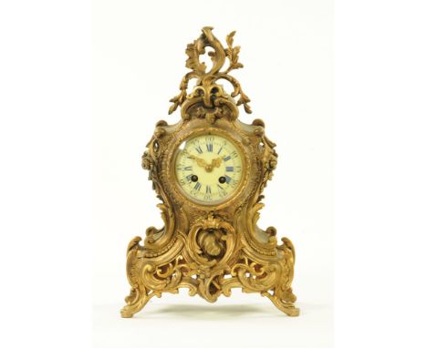 A continental brass mantle clock, in the rococo style with two train striking movement.  Height 40 cm, width 24 cm, depth 13 