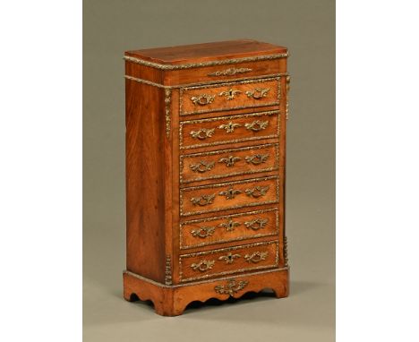 A late 19th/early 20th century continental miniature chest of six drawers with gilt brass mounts, canted angles and raised on