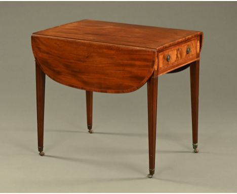 An early 19th century mahogany Pembroke table, crossbanded and inlaid, with frieze drawer to either end and raised on moulded