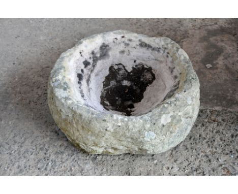 A circular sandstone trough, with drain hole to centre.  diameter +/- 50 cm, height 21 cm.