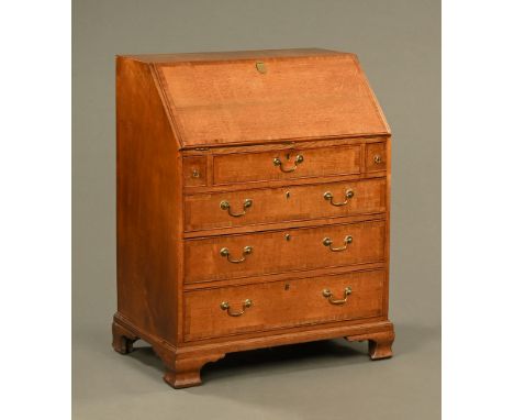 A George III oak bureau, with fall front fitted pigeonhole interior above graduating drawers on ogee bracket feet.  Height 10