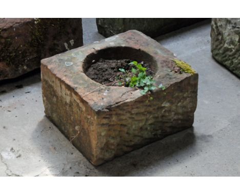 A rectangular sandstone trough, with circular aperture.  Height 26 cm, width 44 cm, depth 39 cm.