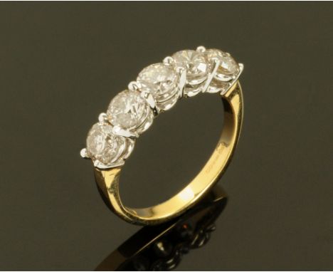 An 18 ct gold two tone five stone half eternity ring, set with diamonds weighing +/- 2.04 carats.  Size N. (see illustration)