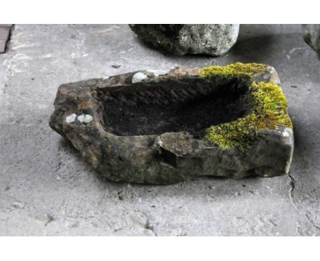 A rectangular sandstone trough, with angled corner.  Height 21 cm, maximum width 76 cm, depth 43 cm.