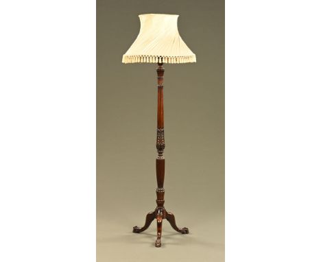 A mahogany lamp standard, with reeded column and three downswept legs terminating in claw feet. CONDITION REPORT: The lamp is