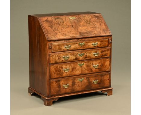 An 18th century walnut bureau, well figured and with fitted interior and tooled leather writing surface, with four drawers wi