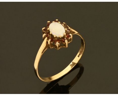 A 9 ct gold opal and garnet ring. Size P.