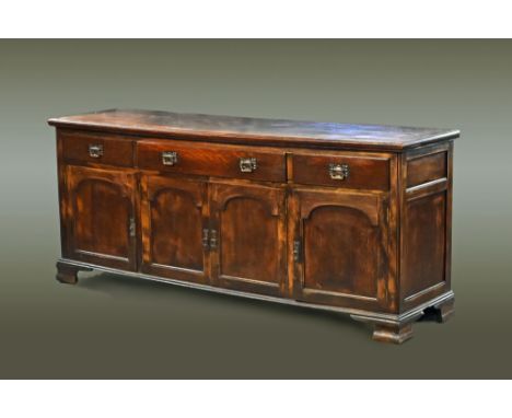 A large late Victorian oak sideboard, fitted with a series of drawers and cupboards and raised on bracket feet.  Height 96 cm