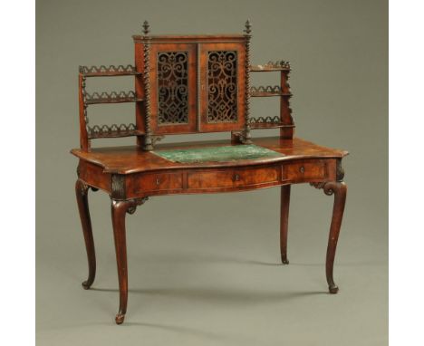 A Victorian mahogany writing table, with superstructure and green leather writing surface, the base of shaped outline fitted 