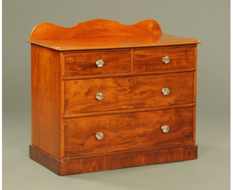 A Victorian mahogany chest of drawers, with rear upstand and with two short and two long graduated drawers with glass knob ha