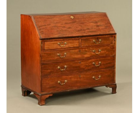 A George III mahogany bureau, with a fitted interior with satinwood and marquetry inlaid central cupboard between a series of