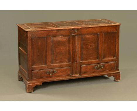 A George III oak mule chest, with three panelled top and panelled front carved with the date 1782, fitted with two drawers an