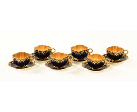 A set of six Coalport blue and gilt shaped coffee cups and saucers. CONDITION REPORT: The six saucers and four of the cups do