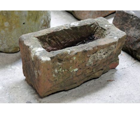A rectangular sandstone trough.  Height 29 cm, width 58 cm, depth 32 cm.