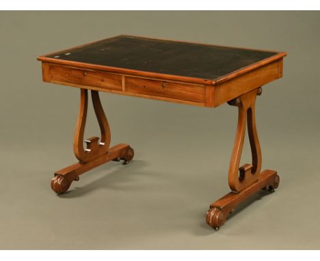 A Regency mahogany library table, with tooled leather writing surface and with two actual and two dummy frieze drawers with s