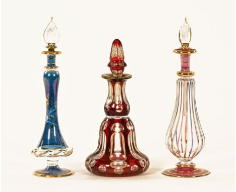 A 19th century bohemian amber glass overlay and gilt flask with stopper, and two Venetian glass flasks.  Tallest 21 cm. CONDI