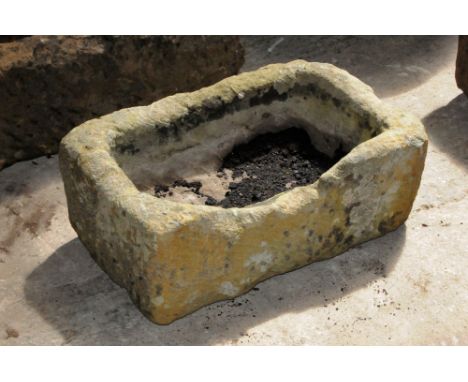 A small sandstone trough.  Height 23 cm, width 58 cm, depth 35 cm.