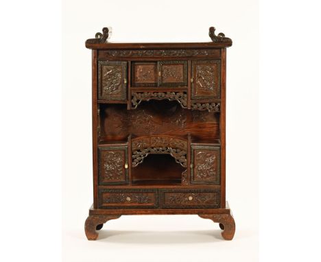 A late 19th/early 20th century Japanese table cabinet, fitted with a series of drawers and cupboards and raised on bracket fe