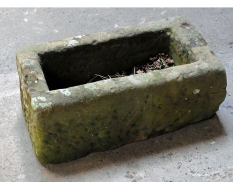 A small rectangular sandstone trough.  Height 23 cm, width 57 cm, depth 32 cm.