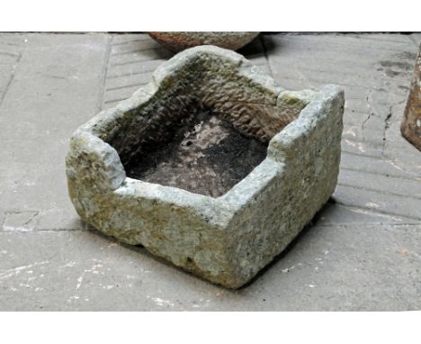 A sandstone trough, square form.  Height at tallest point 43 cm, width 62 cm, depth 62 cm.