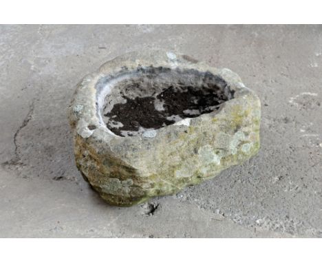 A sandstone trough of shaped outline, with shallow recess.  Height +/- 27 cm, width 60 cm, depth 50 cm.