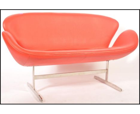 After Arne Jacobsen - Swan sofa - A Fritz Hansen style 20th Century red leather shaped and padded sofa raised on satin polish