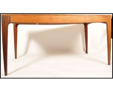 Youngers - A 1970's retro vintage teak wood extending table having the overlapping leg join and tapering with the fold out le