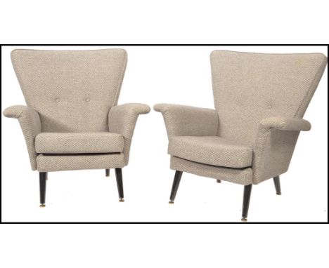 Vono - A 1950's vintage pair of matching high back armchairs having wide angled back rests and angular armrests finished in a