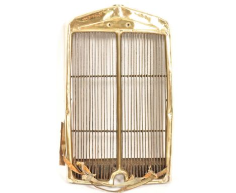 An early 20th century vintage antique industrial high polished brass and steel decorative car radiator grill. Measures 75cm x