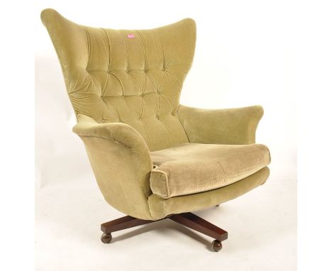 G-Plan - Model 6250 - A 1960's retro vintage large wing back swivel chair / armchair upholstered in green velour and button b