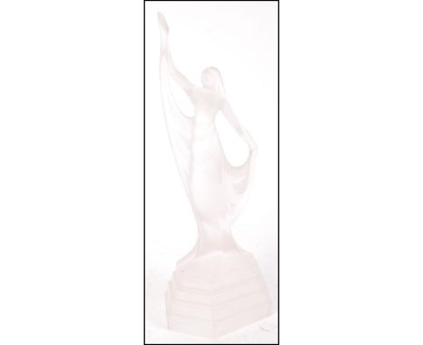 An Art Deco antique vintage frosted pressed glass figure depicting a female in a long dress upon a stepped form. Measures 28c