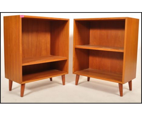 A pair of Danish 1970's teak wood open bookcase with a single shelf to each raised on short round tapering legs, one having a