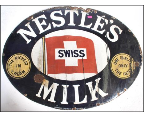 An early 20th century Industrial oval enamel shop advertising sign for ' Nestles Swiss Milk ' The sign in original&nbsp; whit