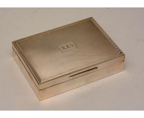 A silver cigarette box, hallmarks for London 1978 maker SJR, the hinged lid with engine turned decoration and reeded edges, c