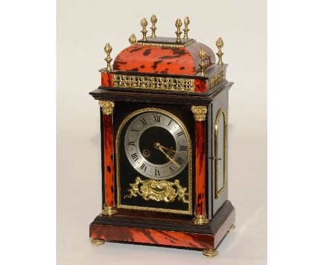 A French red faux tortoiseshell mantel clock, with glazed door enclosing silvered chapter ring above ormolu cartouche with wi