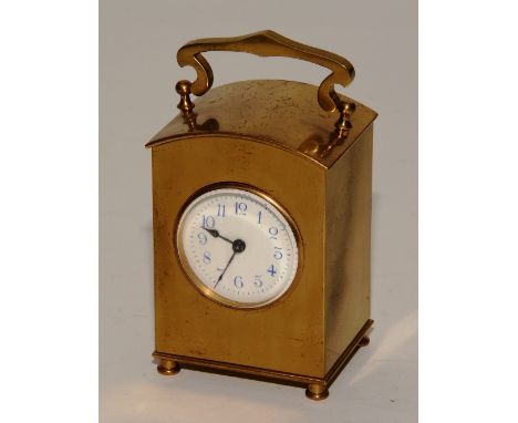 A late 19th century French brass carriage clock, with carry handle above enamel dial with Arabic numerals, in leather travel 